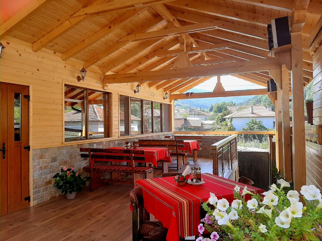 um pavilhão com mesas e cadeiras num camarote em Kovacha Guest House em Raduil