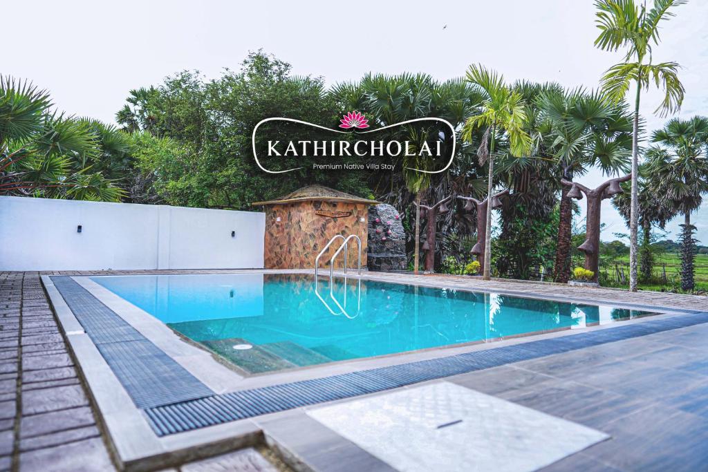 a swimming pool with a sign that reads kathirald at Kathircholai in Trincomalee