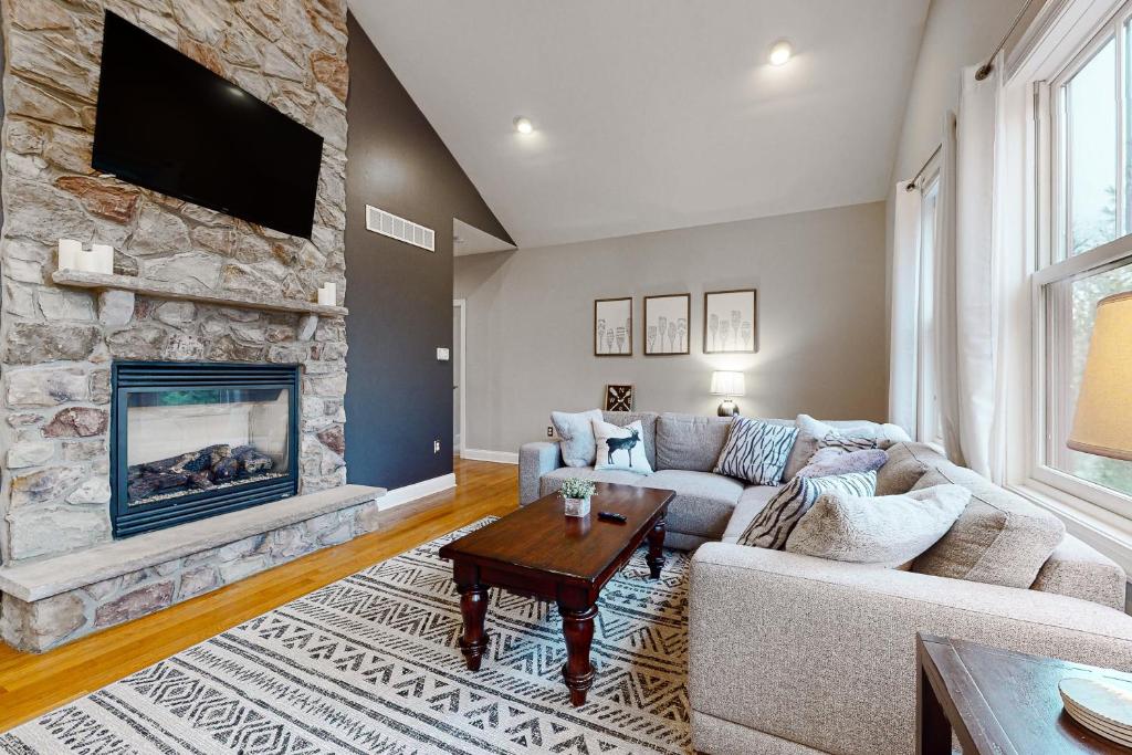 a living room with a couch and a fireplace at 6 Fieldstone Ct in Lake Harmony