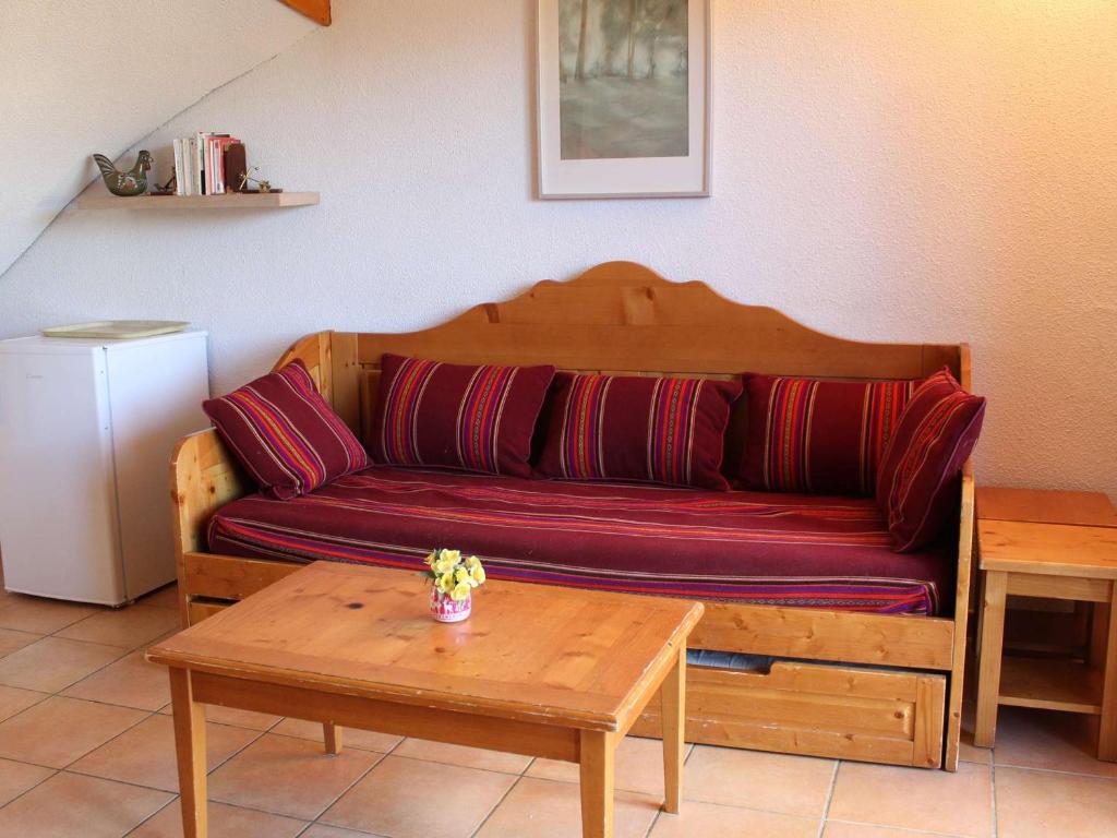 a couch sitting in a living room with a table at Appartement Vars, 5 pièces, 10 personnes - FR-1-330B-139 in Vars