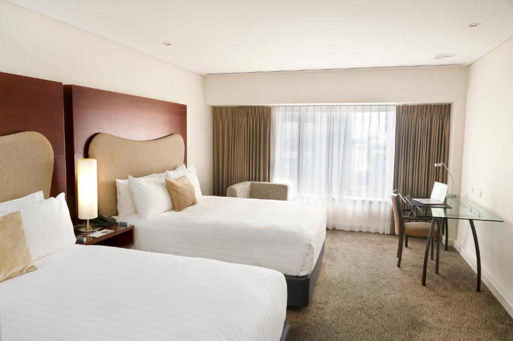 Postel nebo postele na pokoji v ubytování Crowne Plaza Auckland by IHG