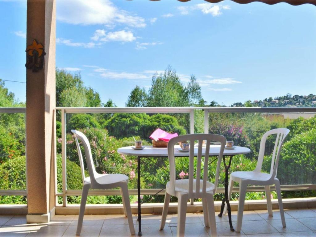 d'une table et de quatre chaises sur un balcon avec vue. dans l'établissement Appartement T2 avec Terrasse Sud, Climatisé, à Proximité Plage - Le Lavandou - FR-1-251-295, au Lavandou