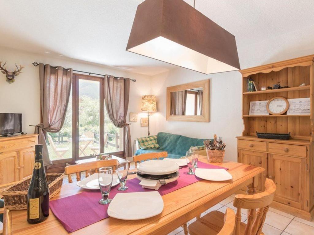 - une cuisine avec une table à manger et des verres à vin dans l'établissement Appartement 3 pièces avec jardin et garage, 6 couchages, Le Monêtier-les-Bains - FR-1-330F-149, au Monêtier-les-Bains