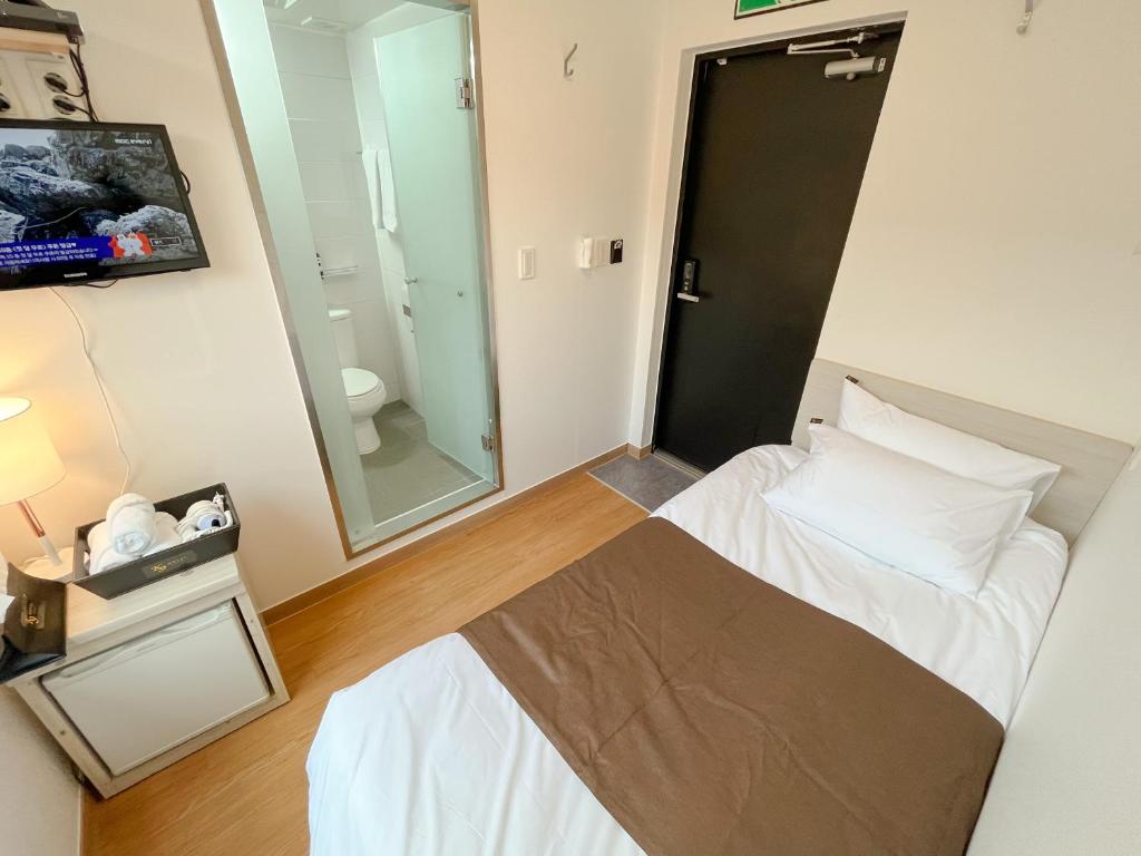 Postel nebo postele na pokoji v ubytování K9 Myeongdong Hotel