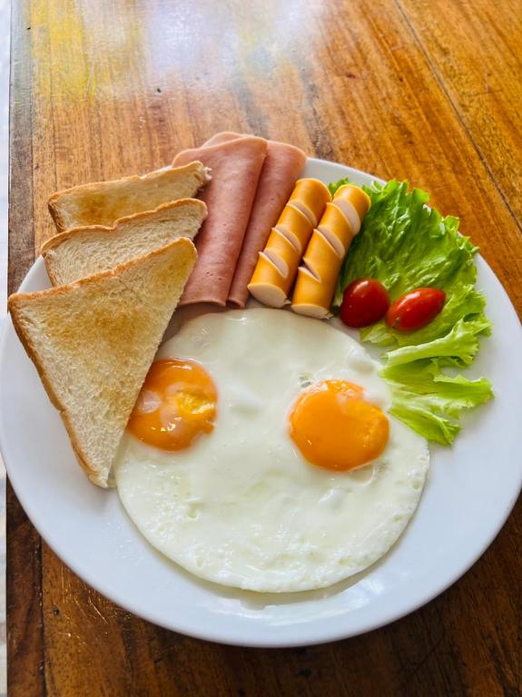 a plate of breakfast food with eggs and toast at Cabana Lipe Beach Resort in Ko Lipe