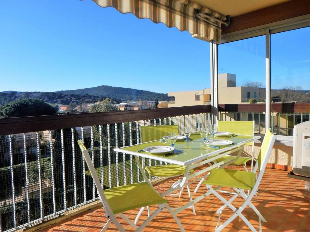a patio with a table and chairs on a balcony at Appartement Le Lavandou, 2 pièces, 4 personnes - FR-1-251-200 in Le Lavandou