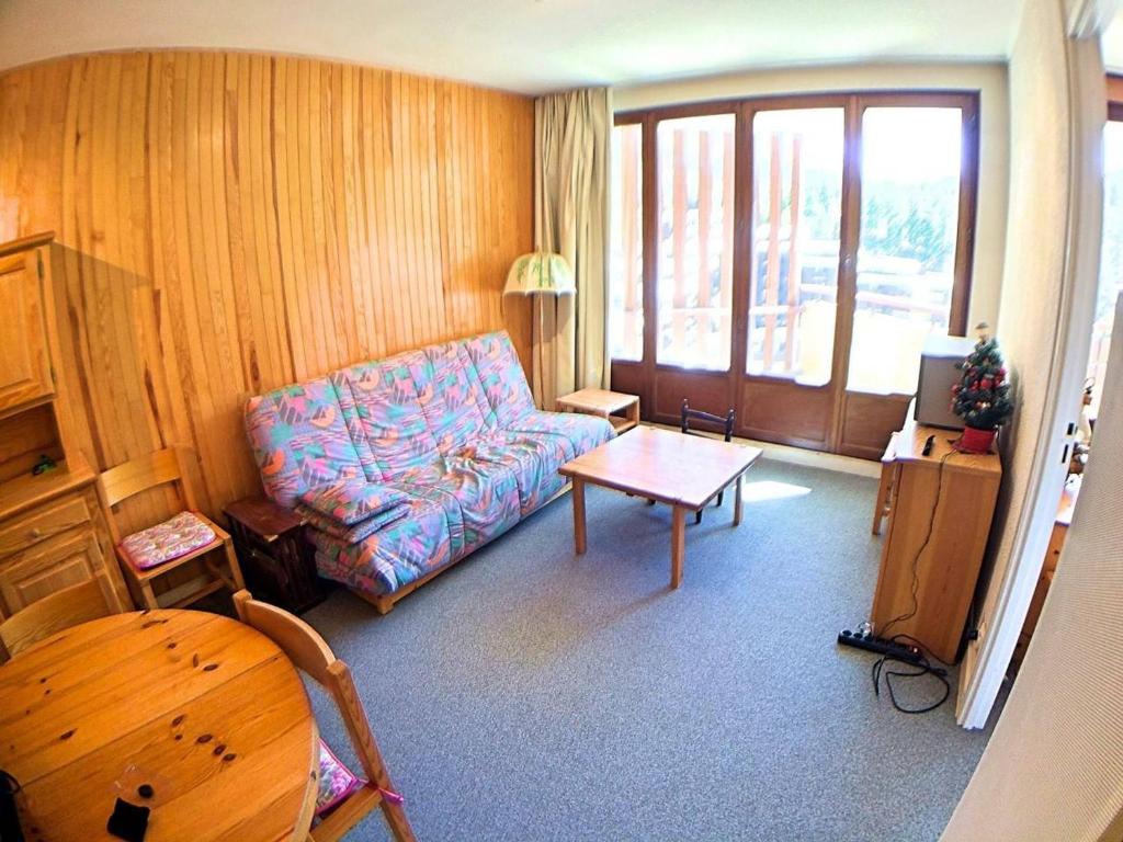 a living room with a couch and a table at Appartement Vars, 2 pièces, 4 personnes - FR-1-330B-63 in Vars