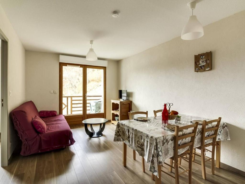 a living room with a table and a couch at Appartement Barèges, 2 pièces, 6 personnes - FR-1-403-34 in Barèges