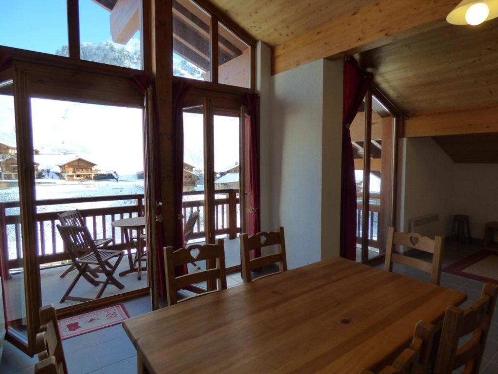 a dining room with a wooden table and chairs at Appartement Le Grand-Bornand, 4 pièces, 8 personnes - FR-1-458-147 in Le Grand-Bornand