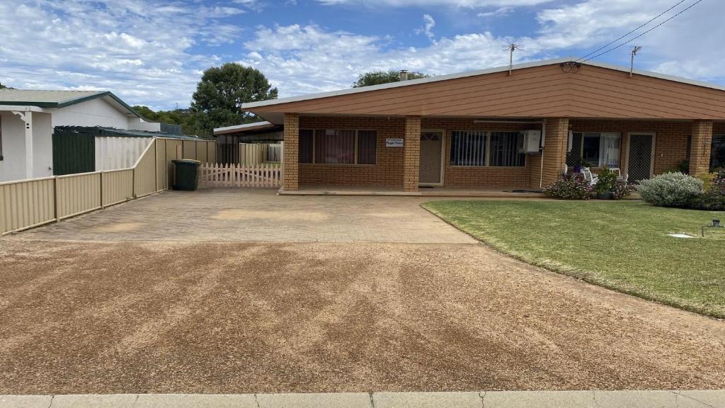 a house with a driveway in front of it at Puggle Palace in Jurien Bay