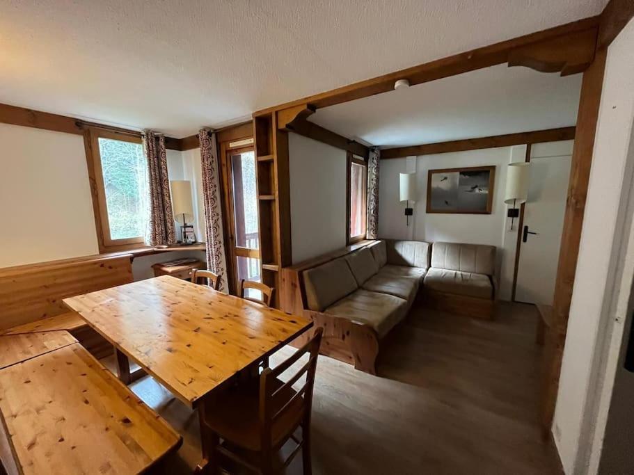 a living room with a wooden table and a couch at Superbe Appartement à Montchavin in Montchavin