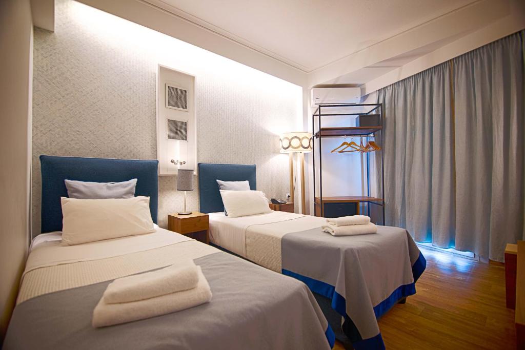 Łóżko lub łóżka w pokoju w obiekcie FALIREON HOTEL