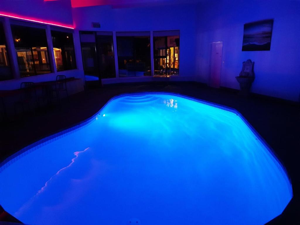 an empty swimming pool in a house at night at Abbotswood Motor Inn in Geelong