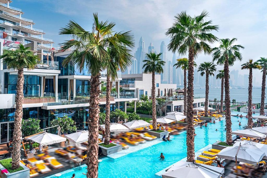 an aerial view of a resort pool with palm trees at Five Palm Residences in Dubai