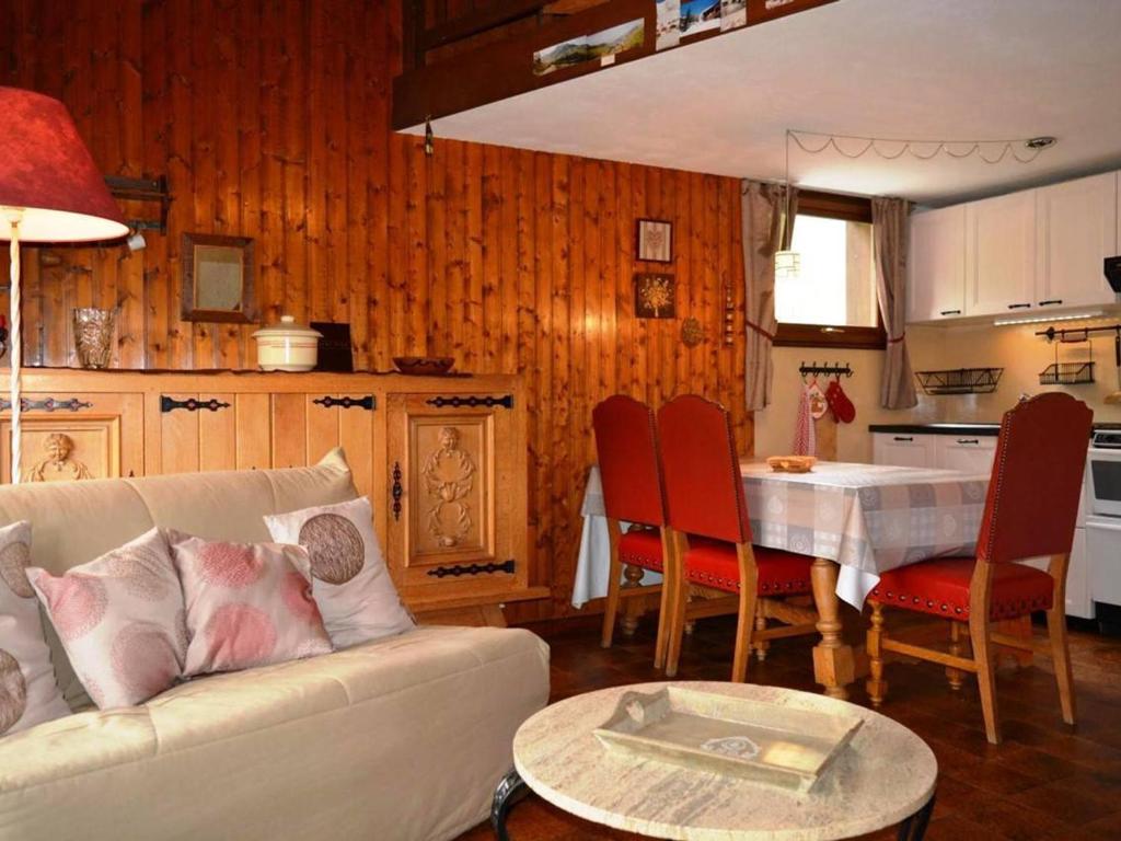 a living room with a couch and a table and a kitchen at Appartement Le Grand-Bornand, 2 pièces, 5 personnes - FR-1-241-167 in Le Grand-Bornand