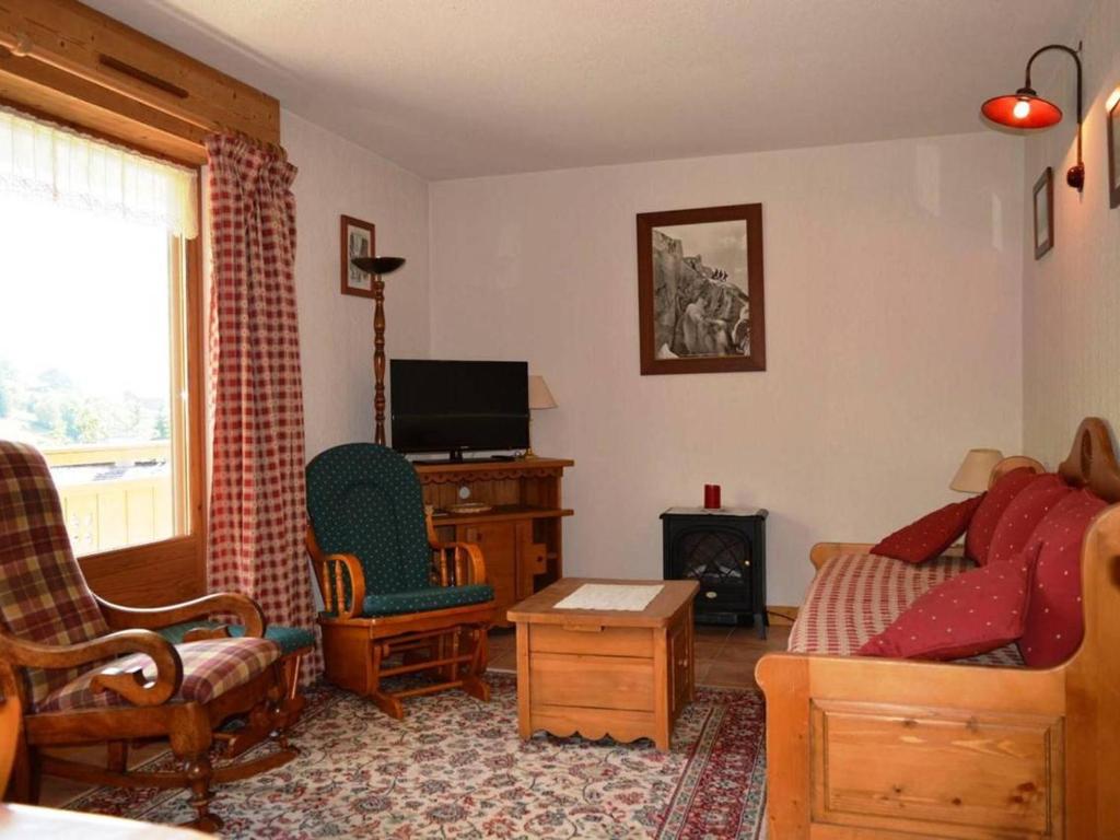 a living room with a tv and a couch and a chair at Appartement Le Grand-Bornand, 3 pièces, 6 personnes - FR-1-241-177 in Le Grand-Bornand
