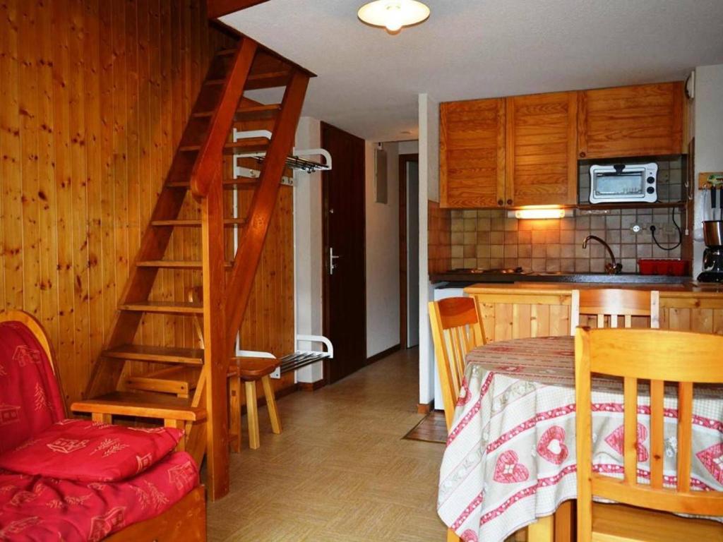 a room with a kitchen and a staircase leading to a bedroom at Appartement Le Grand-Bornand, 1 pièce, 4 personnes - FR-1-241-170 in Le Grand-Bornand