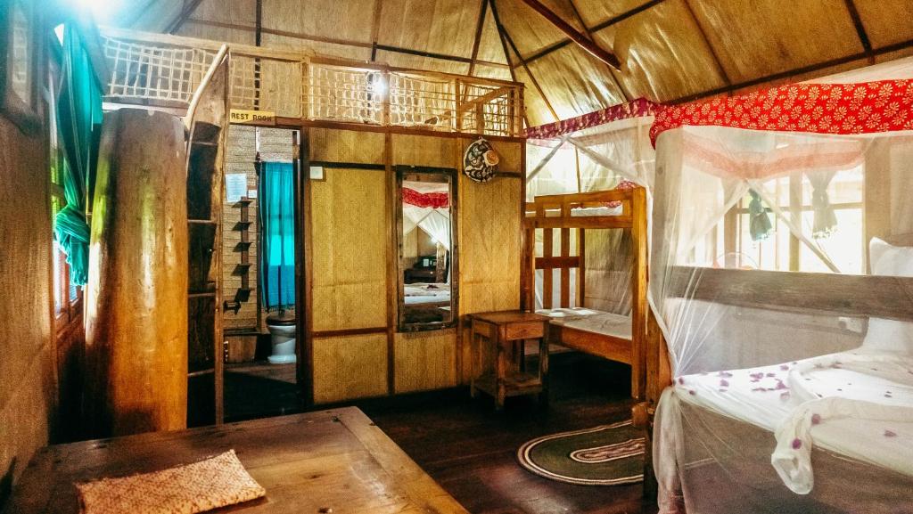 Postel nebo postele na pokoji v ubytování Pemba Eco Lodge