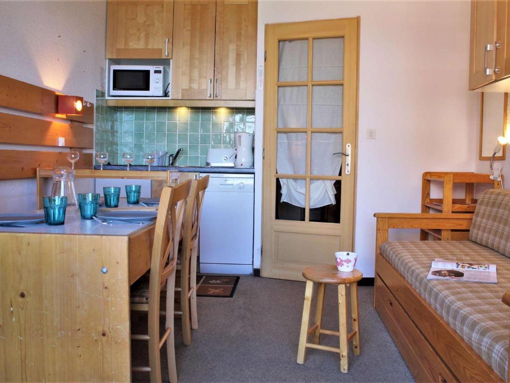 a kitchen with a table and a kitchen with a couch at Studio cabine 4 pers, pied de pistes, animaux acceptés – Risoul 1850 - FR-1-330-221 in Risoul