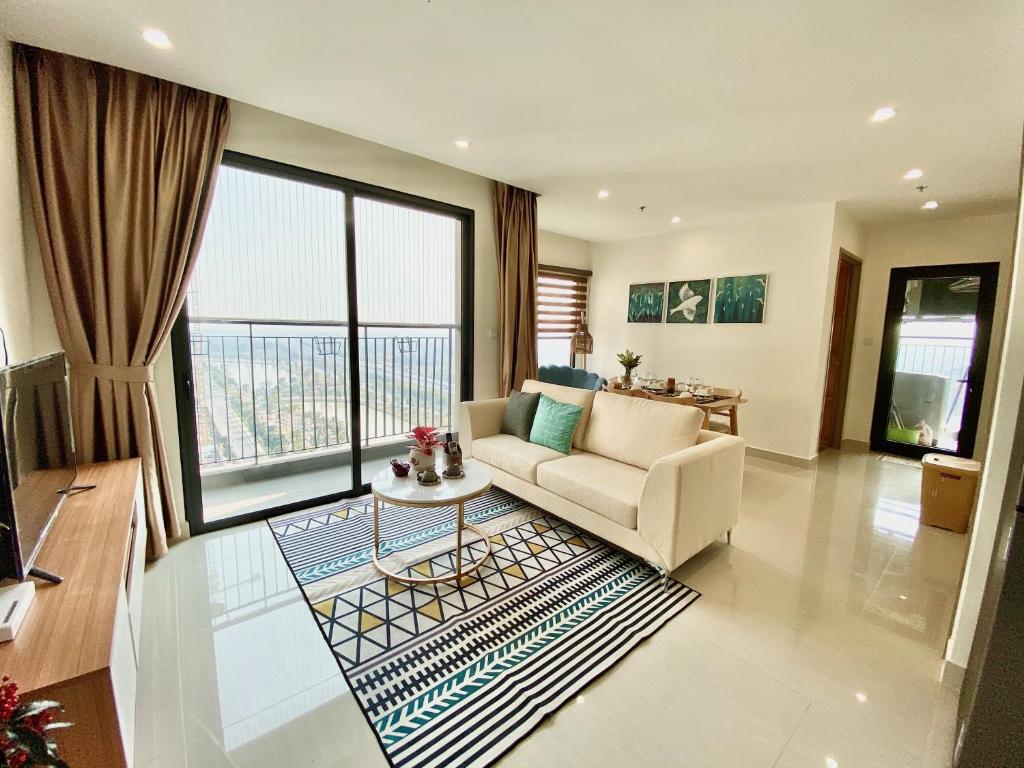 a living room with a couch and a table at QMP - Vinhomes Ocean Park in Hanoi