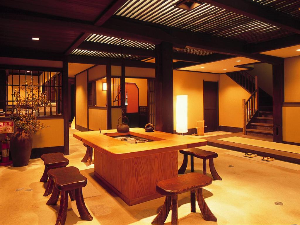 a large room with a island with stools in it at Taikyourou in Miyazu