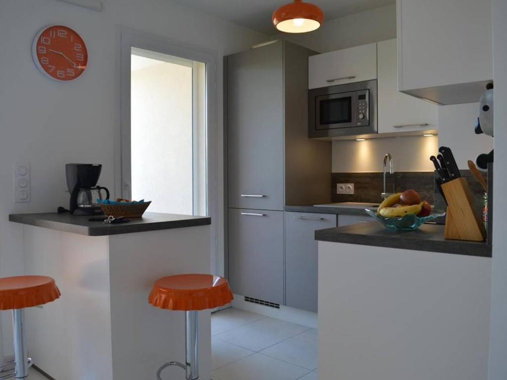 a kitchen with a counter and stools in it at Appartement Saint-Raphaël, 3 pièces, 4 personnes - FR-1-226A-274 in Saint-Raphaël