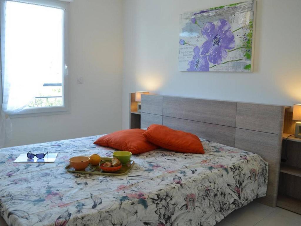 a bedroom with a bed with a tray of food on it at Appartement Saint-Raphaël, 3 pièces, 4 personnes - FR-1-226A-274 in Saint-Raphaël