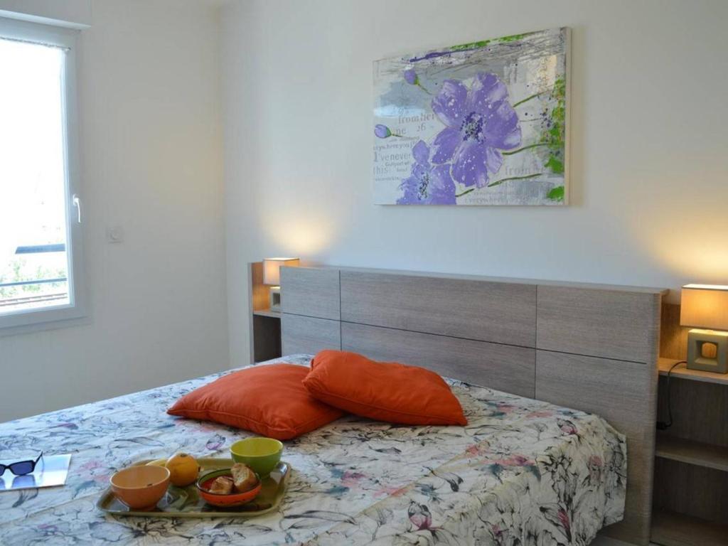 a bedroom with a bed with a tray of food on it at Appartement Saint-Raphaël, 3 pièces, 4 personnes - FR-1-226A-274 in Saint-Raphaël