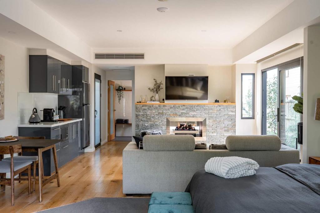 a living room with a couch and a fireplace at Earimil Villas - Waterfront in Mount Eliza