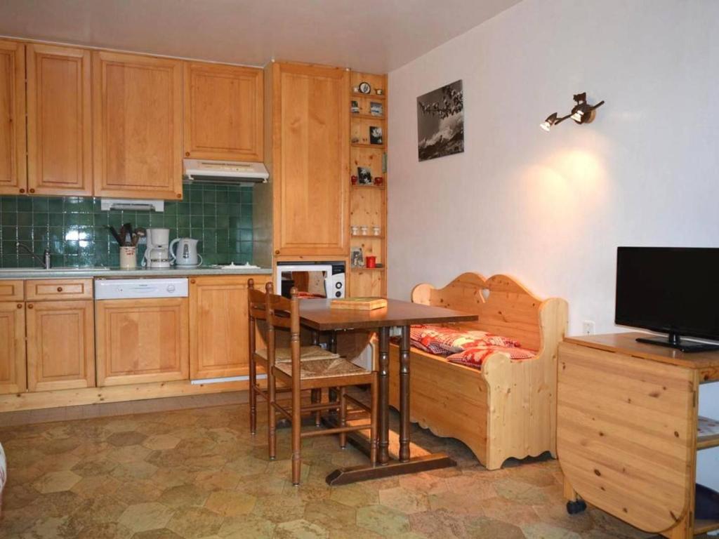 a kitchen with a table and a couch and a table and chairs at Appartement Le Grand-Bornand, 2 pièces, 5 personnes - FR-1-241-147 in Le Grand-Bornand