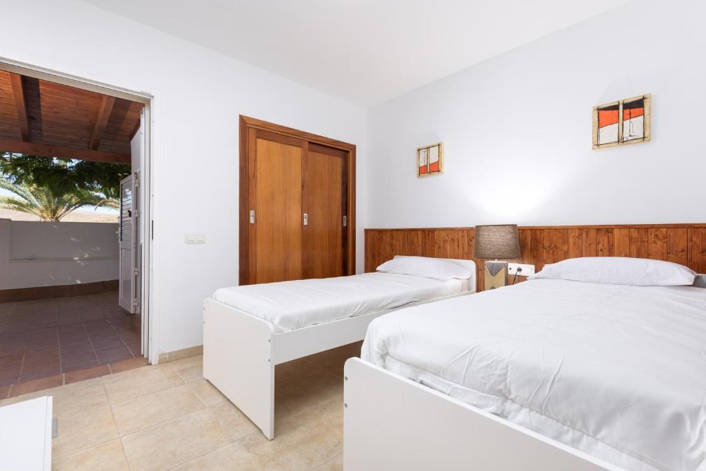 Postel nebo postele na pokoji v ubytování Home2Book Charming Casa El Refugio