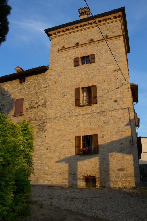 a tall brick building with windows on the side of it at Torre Colombaia in Salsomaggiore Terme