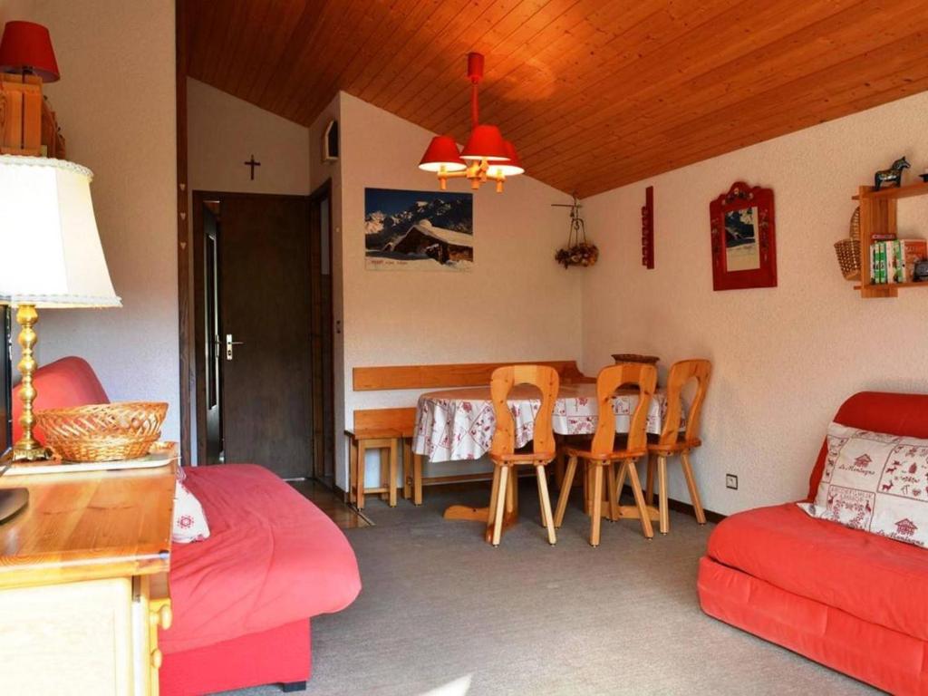 a living room with a couch and a table and chairs at Studio Le Grand-Bornand, 1 pièce, 4 personnes - FR-1-241-12 in Le Grand-Bornand