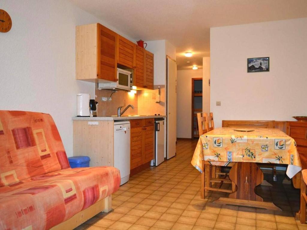 a kitchen and dining room with a table and a kitchen and a room at Appartement Le Grand-Bornand, 2 pièces, 6 personnes - FR-1-241-11 in Le Grand-Bornand