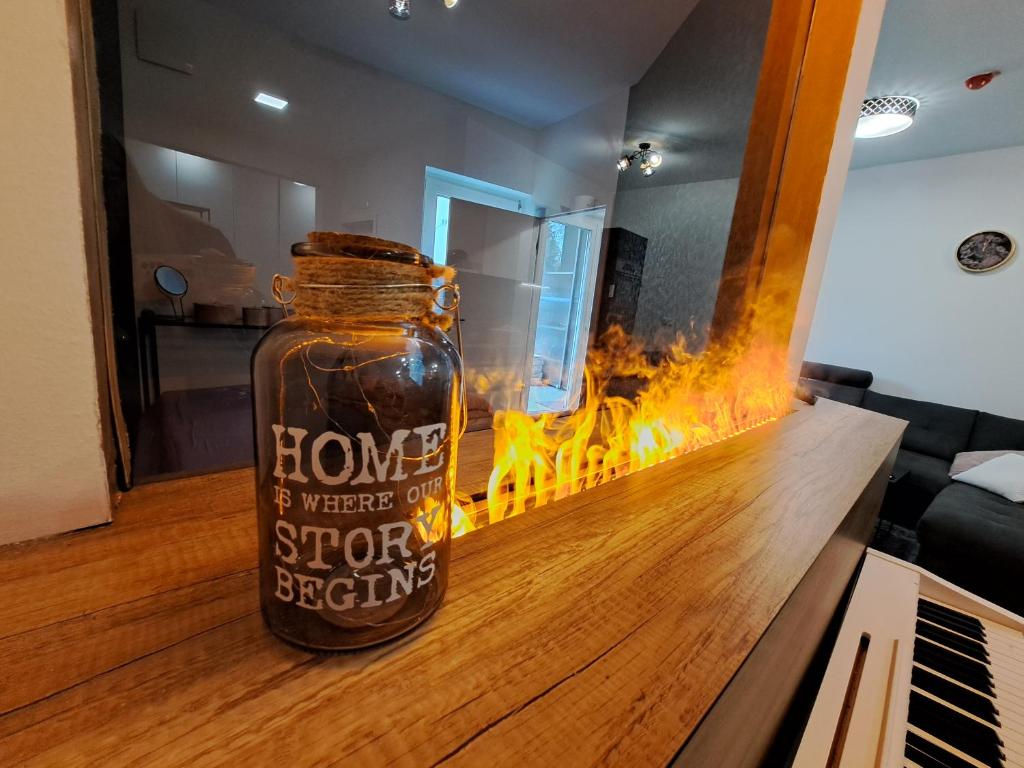 a jar of honey on a counter in a room with fire at Stunning new apartment with free parking near city centre in Ljubljana