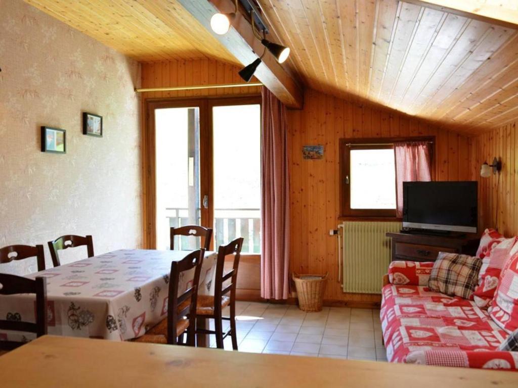 a living room with a table and a couch at Appartement Le Grand-Bornand, 2 pièces, 6 personnes - FR-1-241-94 in Le Grand-Bornand