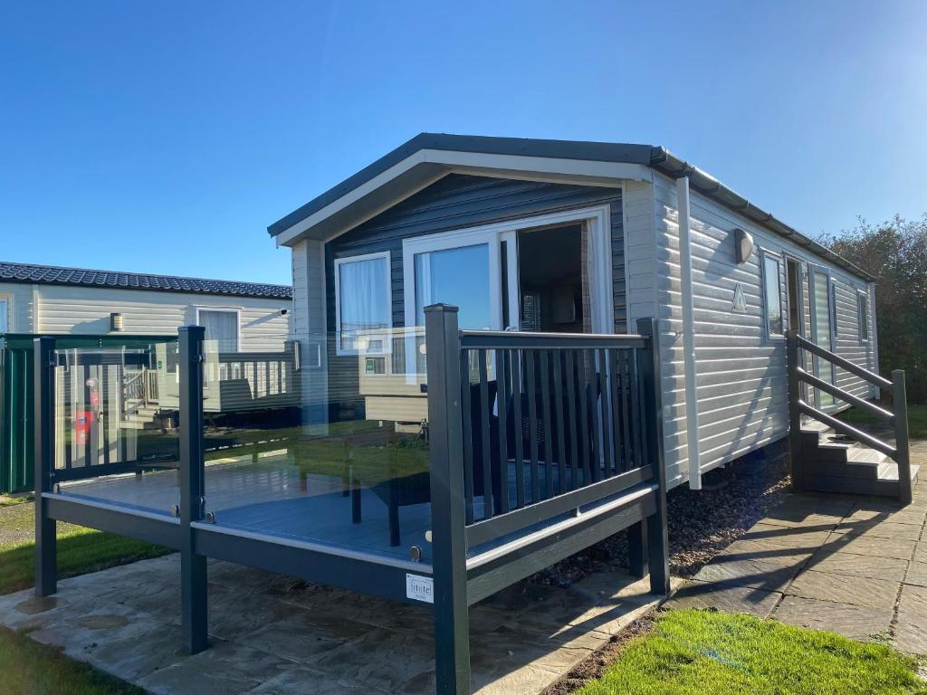 a tiny house with a porch and a deck at Butlins - Skegness in Ingoldmells