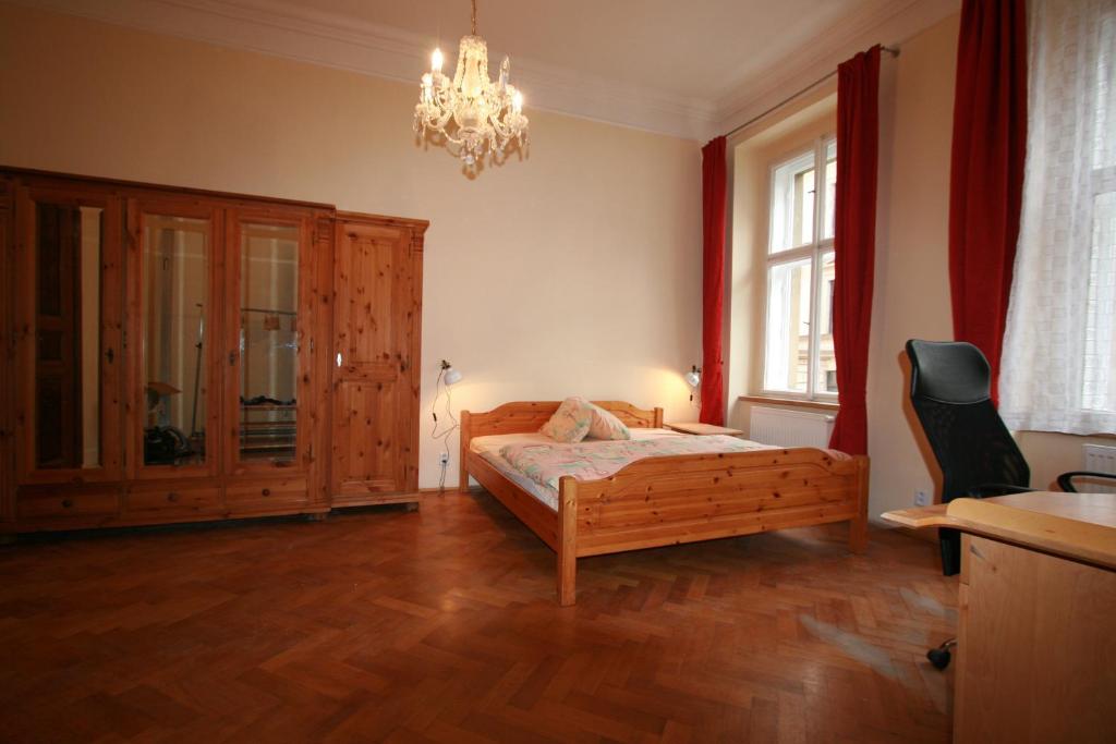 a bedroom with a bed and a chandelier at Apartment No 0B Petrinska 18 - Mala Strana in Prague