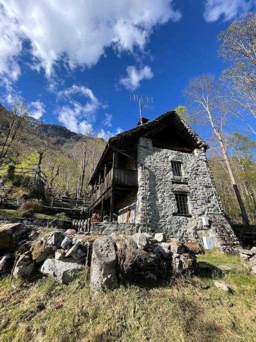 an old stone house on the side of a hill at Chalet Baita Magugnaga in Ceppo Morelli
