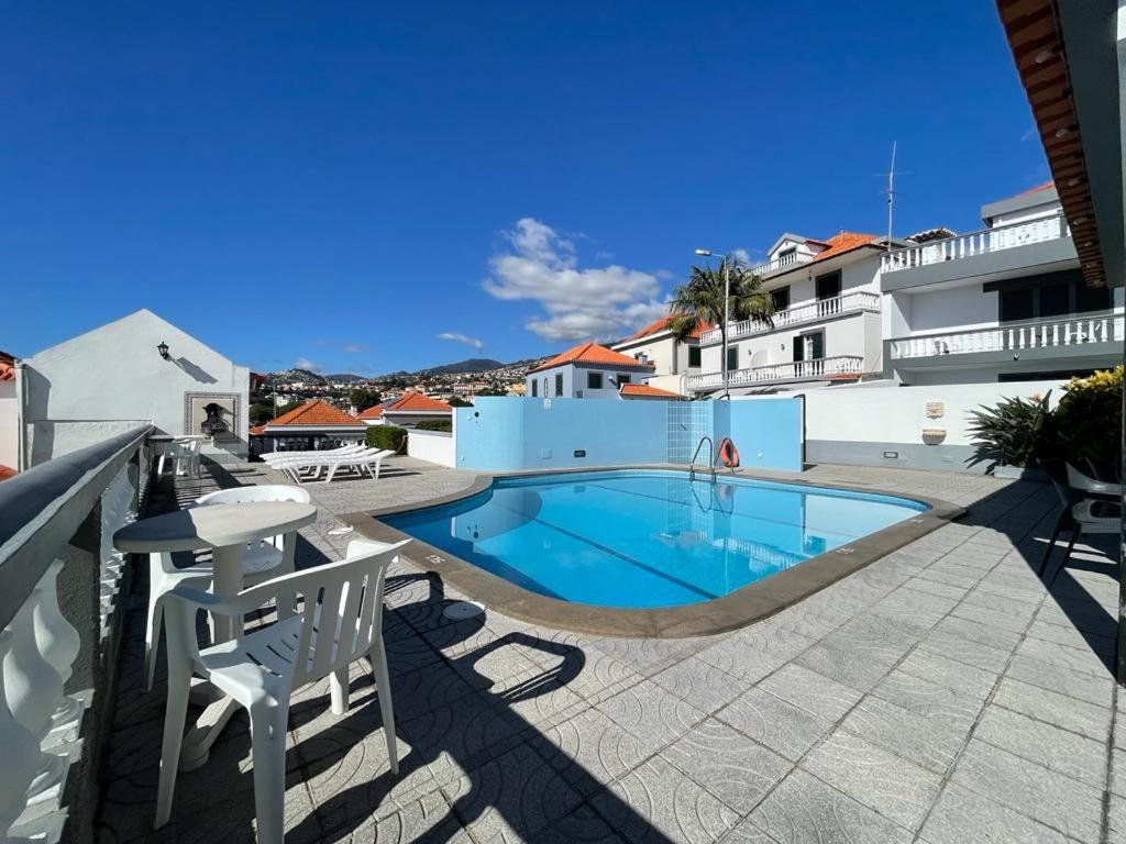 a swimming pool in the middle of a building at Valhalla Panorama - the old Residencial Pina in Funchal