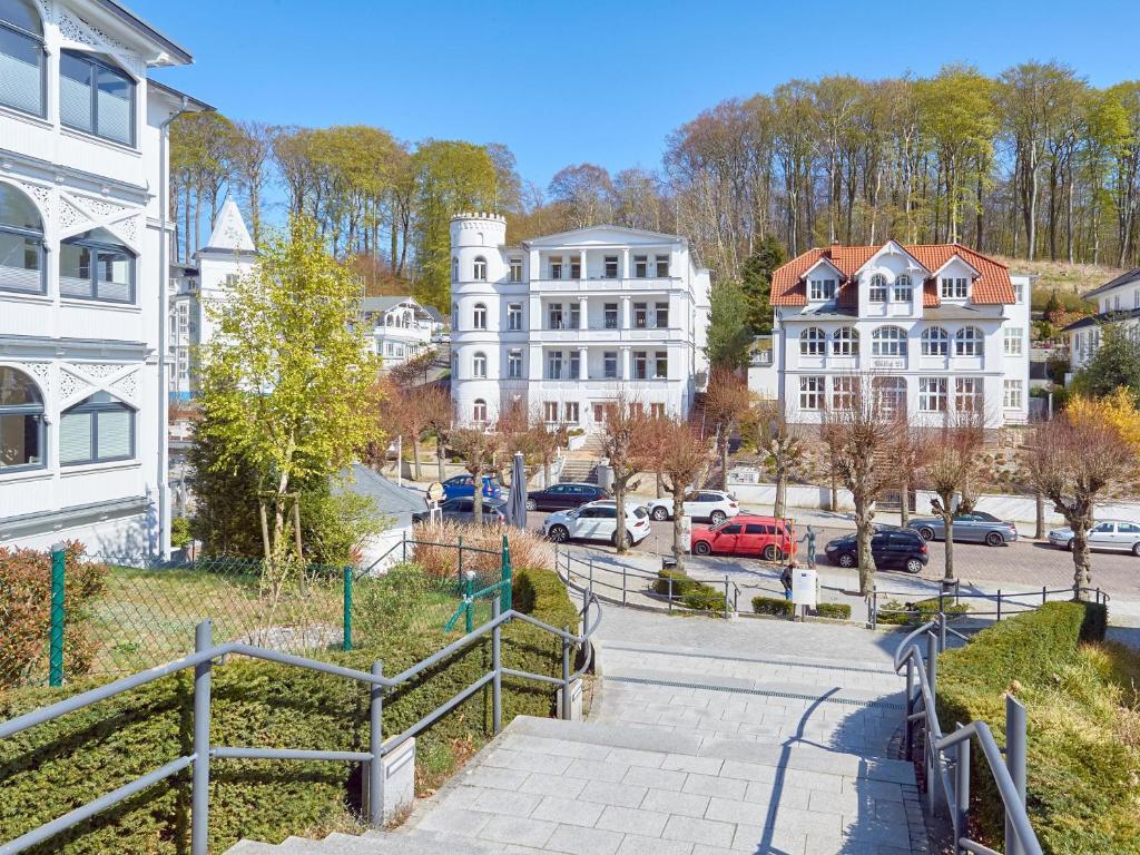 a city street with buildings and cars parked on the street at Ferienwohnung AMAPOLA - Villa Odin in Ostseebad Sellin