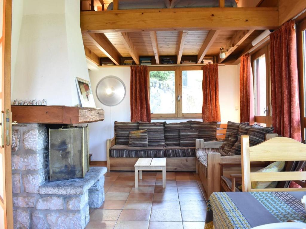 a living room with a couch and a fireplace at Chalet Méribel, 5 pièces, 10 personnes - FR-1-180-188 in Méribel