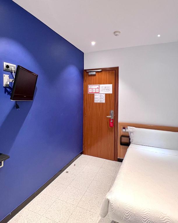 Postel nebo postele na pokoji v ubytování Hostal Apolo