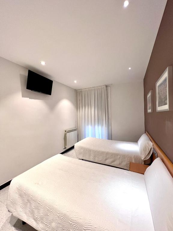 Postel nebo postele na pokoji v ubytování Hostal Apolo