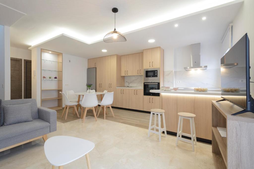a kitchen and living room with a couch and a table at DUPLEX VISTANEVADA MARACENA in Maracena