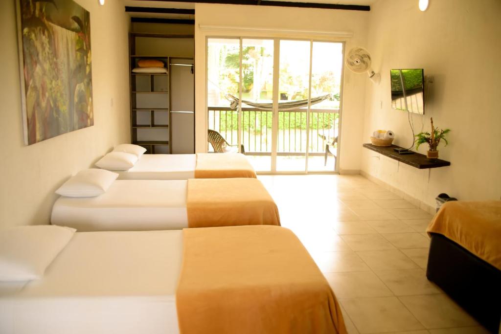 Postel nebo postele na pokoji v ubytování Finca Hotel Loma Verde