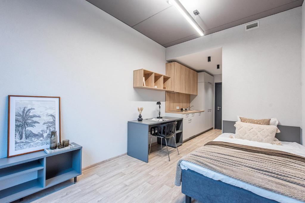 a bedroom with a bed and a desk at SHED Vilnius Coliving in Vilnius