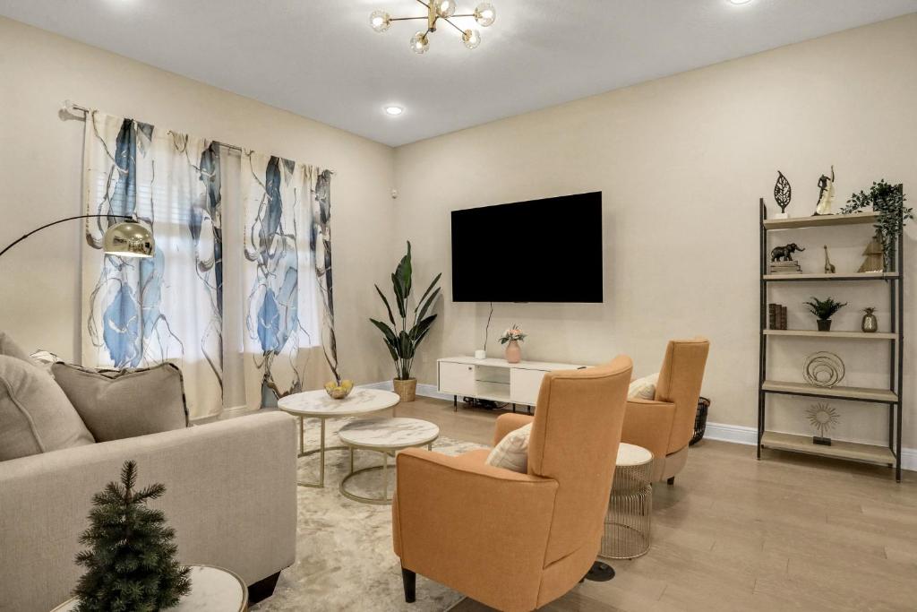 uma sala de estar com um sofá e uma televisão em Newport Retreat em Tampa