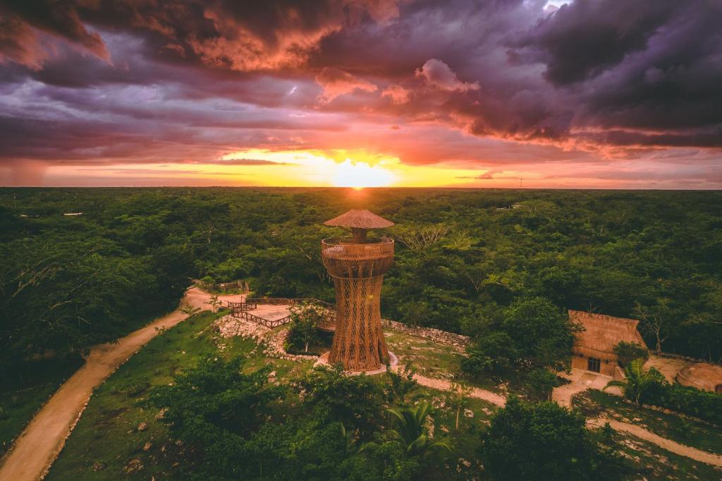 an aerial view of a tower with the sunset in the background at Destino Mío by AKEN Soul 