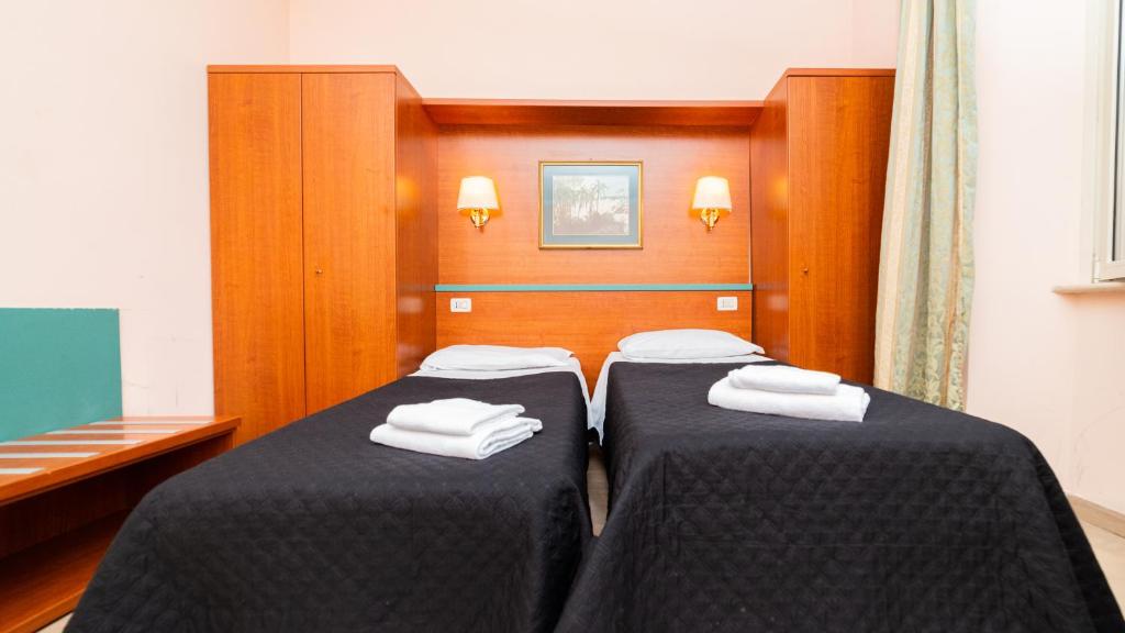Postel nebo postele na pokoji v ubytování Hotel Center 2